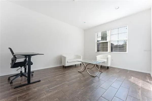 a bedroom with a bed and a wall painting