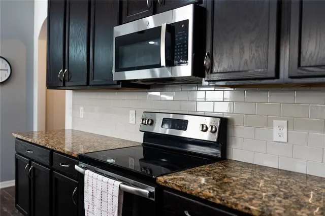 a large white bed in a bedroom next to a window