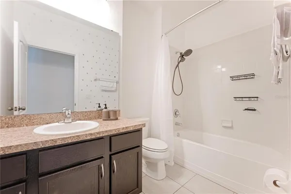 a kitchen with a sink and wooden floor