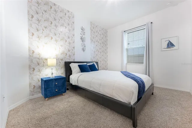 a vase of flowers sitting on a table with a mirror