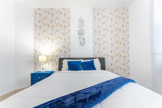 a bedroom with two beds and a chandelier