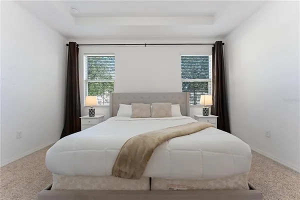 a living room with furniture a rug and a flat screen tv