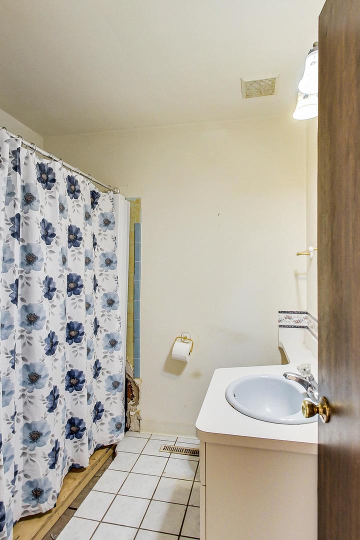 2024 Central Road Glenview, IL 60025 - Photo 12 of 15 a bathroom with a sink toilet and shower
