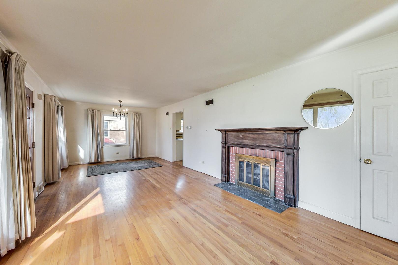 2024 Central Road Glenview, IL 60025 - Photo 3 of 15 a view of an empty room with window and wooden floor