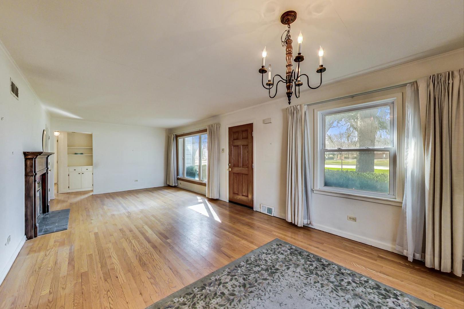 2024 Central Road Glenview, IL 60025 - Photo 4 of 15 a view of a livingroom with wooden floor and chandelier