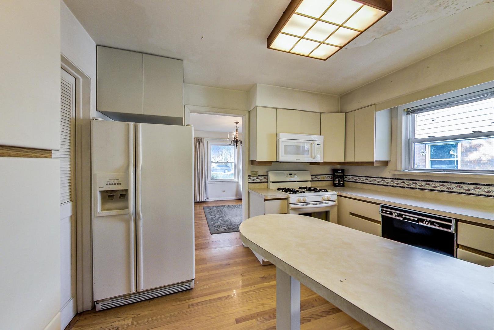 2024 Central Road Glenview, IL 60025 - Photo 5 of 15 a kitchen with stainless steel appliances granite countertop a refrigerator a stove and a sink with cabinets