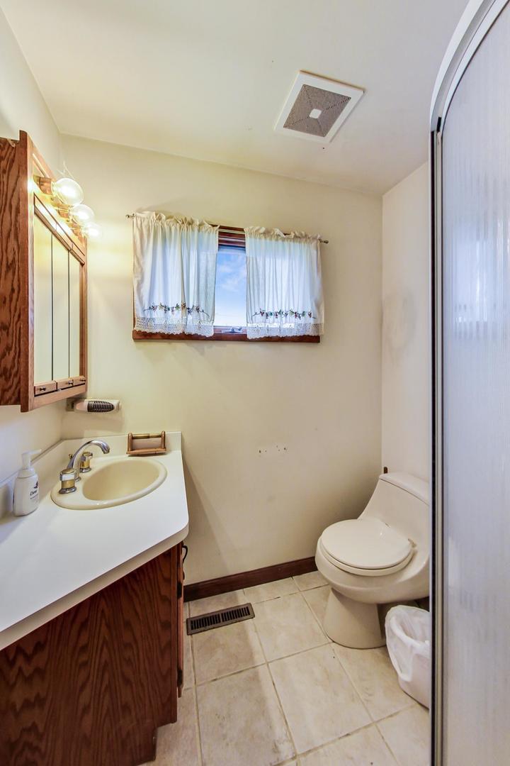 2024 Central Road Glenview, IL 60025 - Photo 8 of 15 a bathroom with a sink toilet and mirror