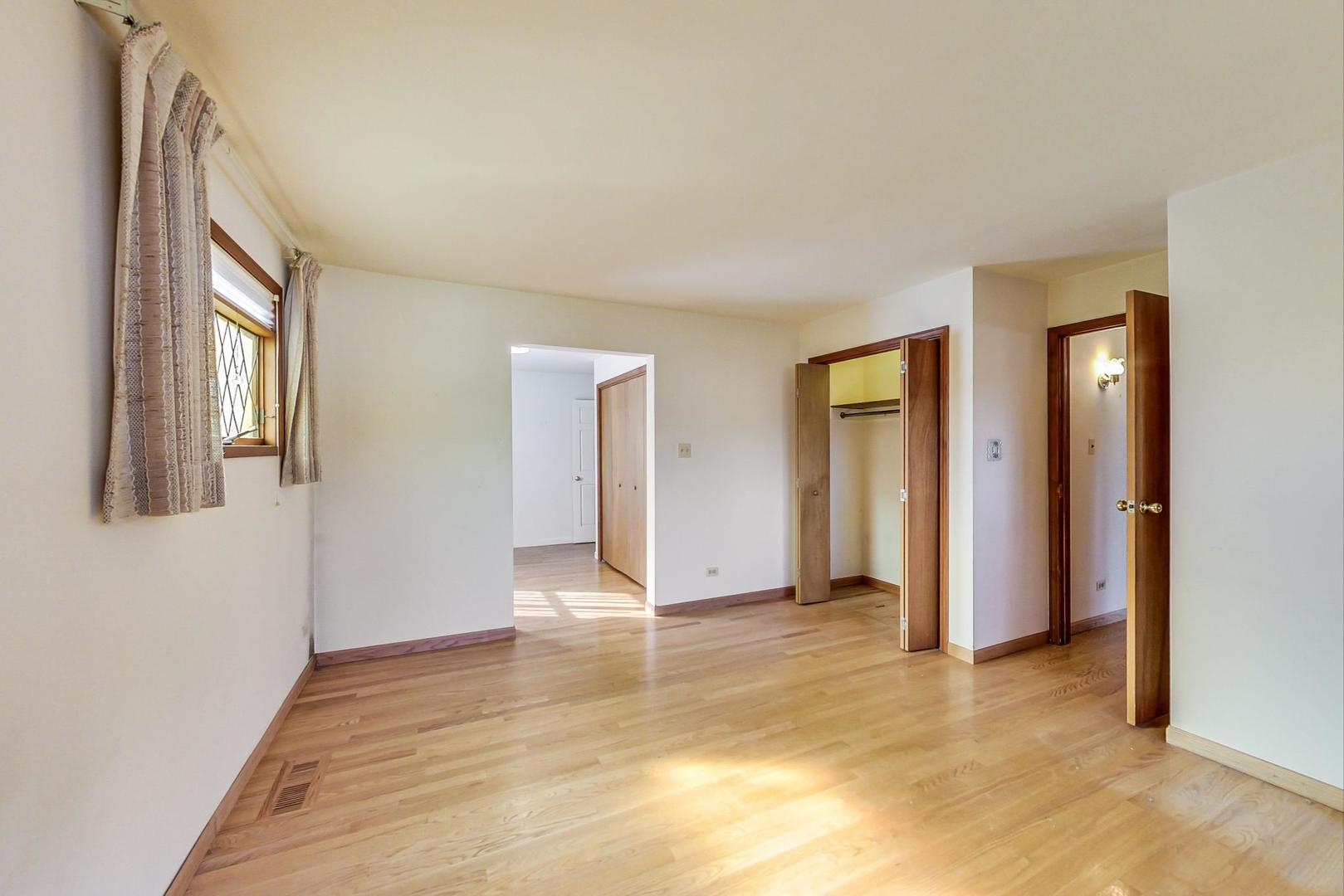 2024 Central Road Glenview, IL 60025 - Photo 9 of 15 a view of an empty room with window and wooden floor