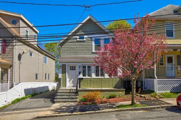 a front view of a house with garden