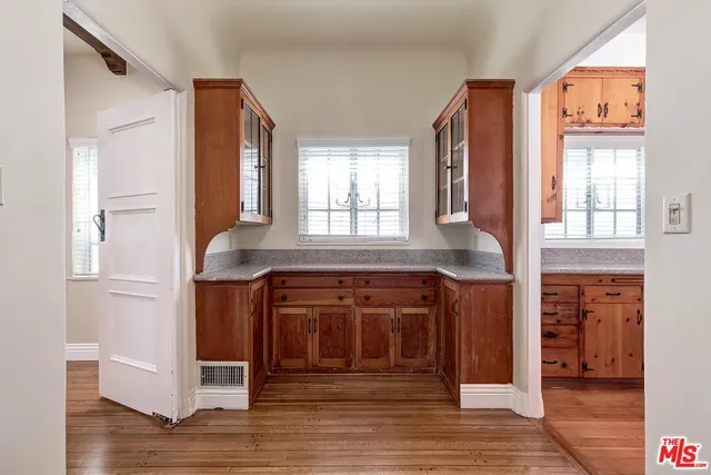 a kitchen with stainless steel appliances granite countertop a sink and wooden cabinets