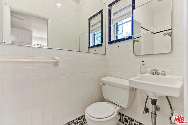 a bathroom with a granite countertop toilet a sink and bathtub
