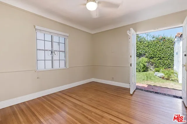 a view of a house with backyard sitting area and garden