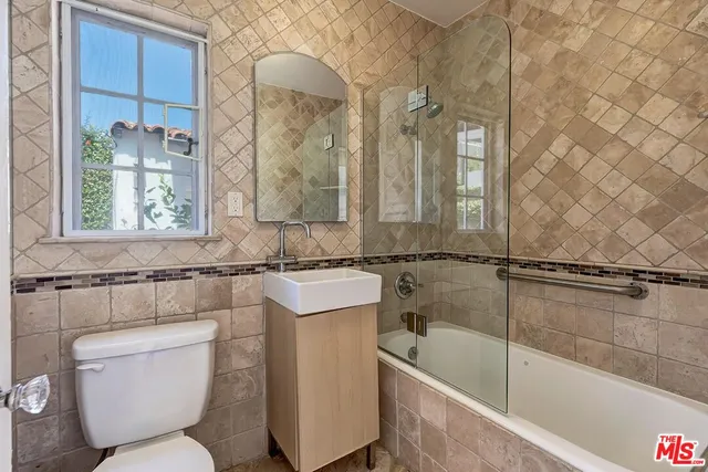 a view of a patio with table and chairs and potted plants