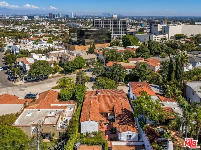 an aerial view of residential houses with city view