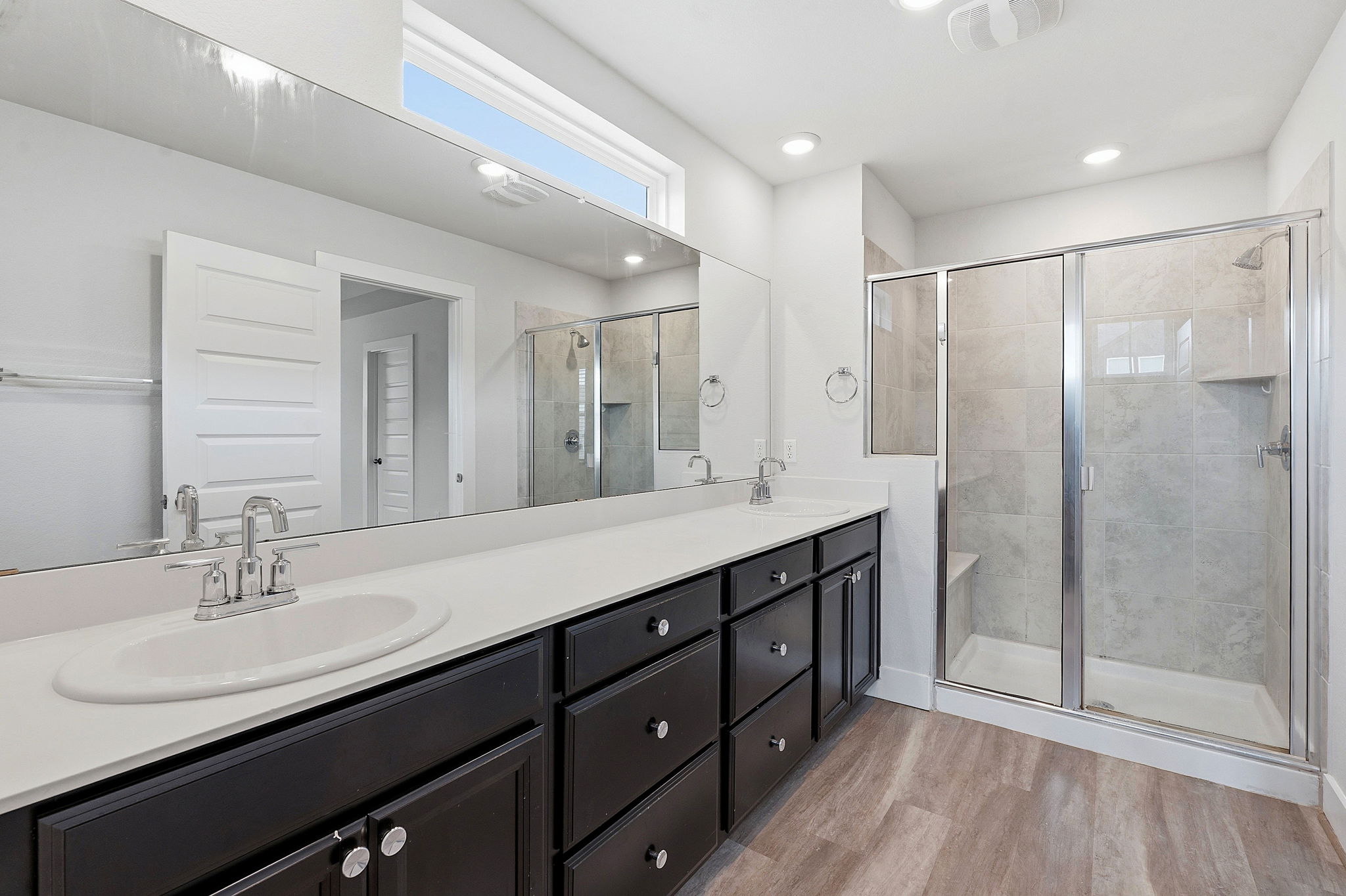 7105 Silver Star Lane, Unit 59 Austin, TX 78744 - Photo 11 of 19 a bathroom with a double vanity sink mirror and shower