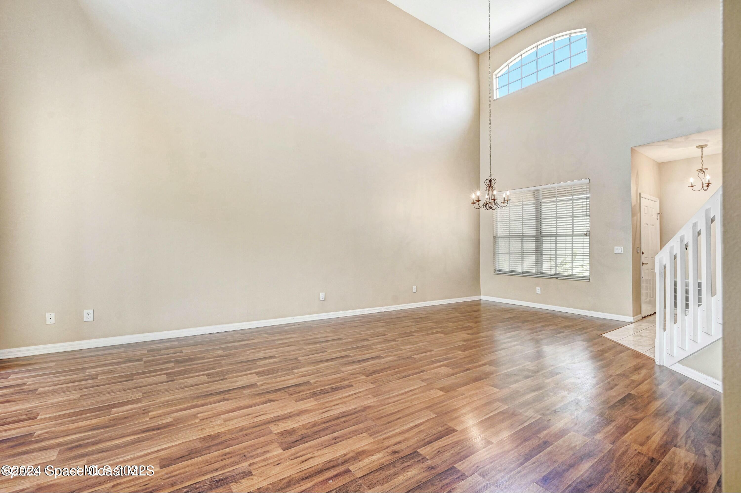 244 Intrepid Way Indialantic, FL 32903 - Photo 13 of 42 a view of an empty room with wooden floor and a window