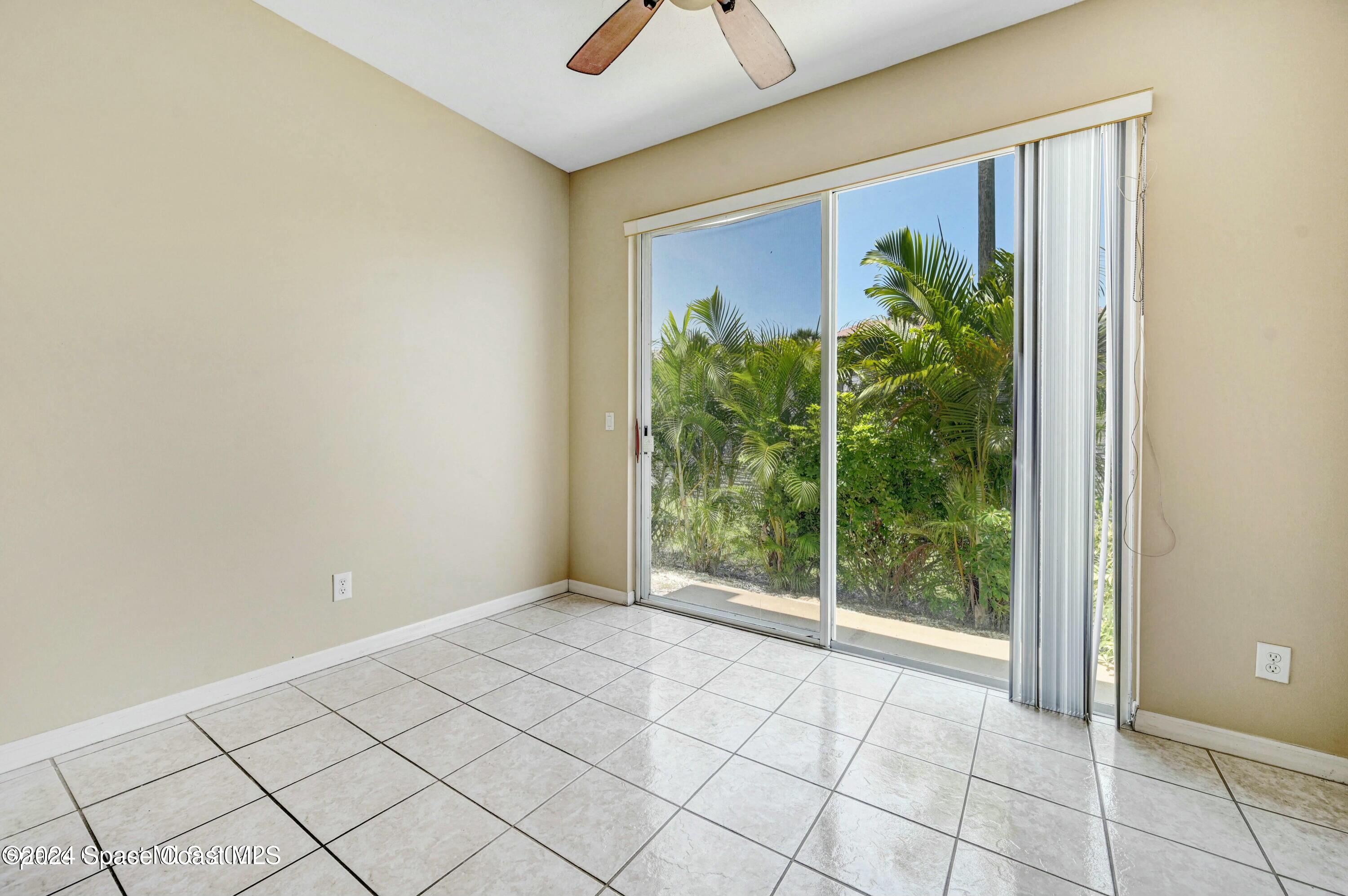 244 Intrepid Way Indialantic, FL 32903 - Photo 15 of 42 a view of an empty room and window a ceiling fan and windows
