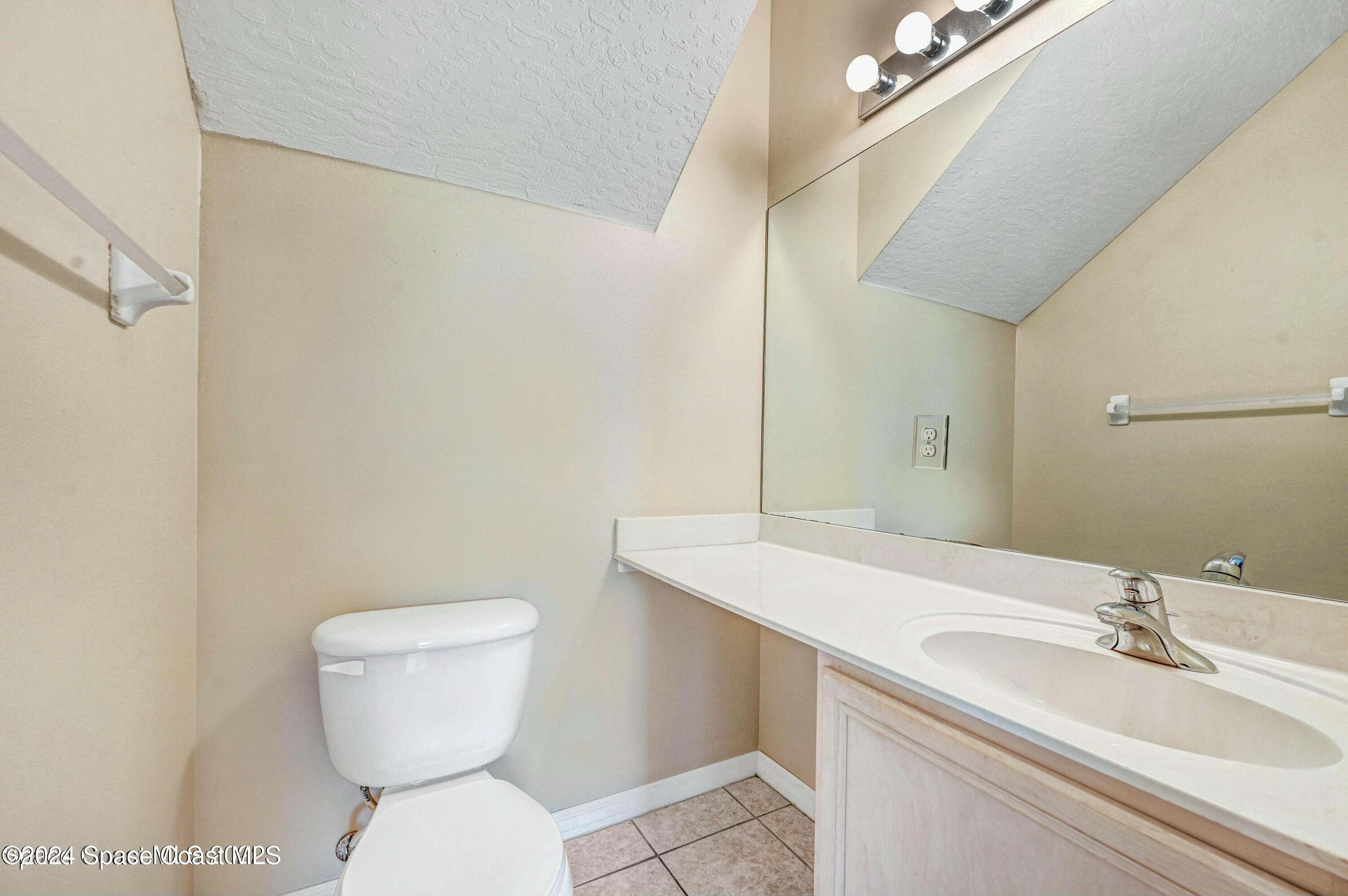 244 Intrepid Way Indialantic, FL 32903 - Photo 16 of 42 a bathroom with a toilet sink and mirror