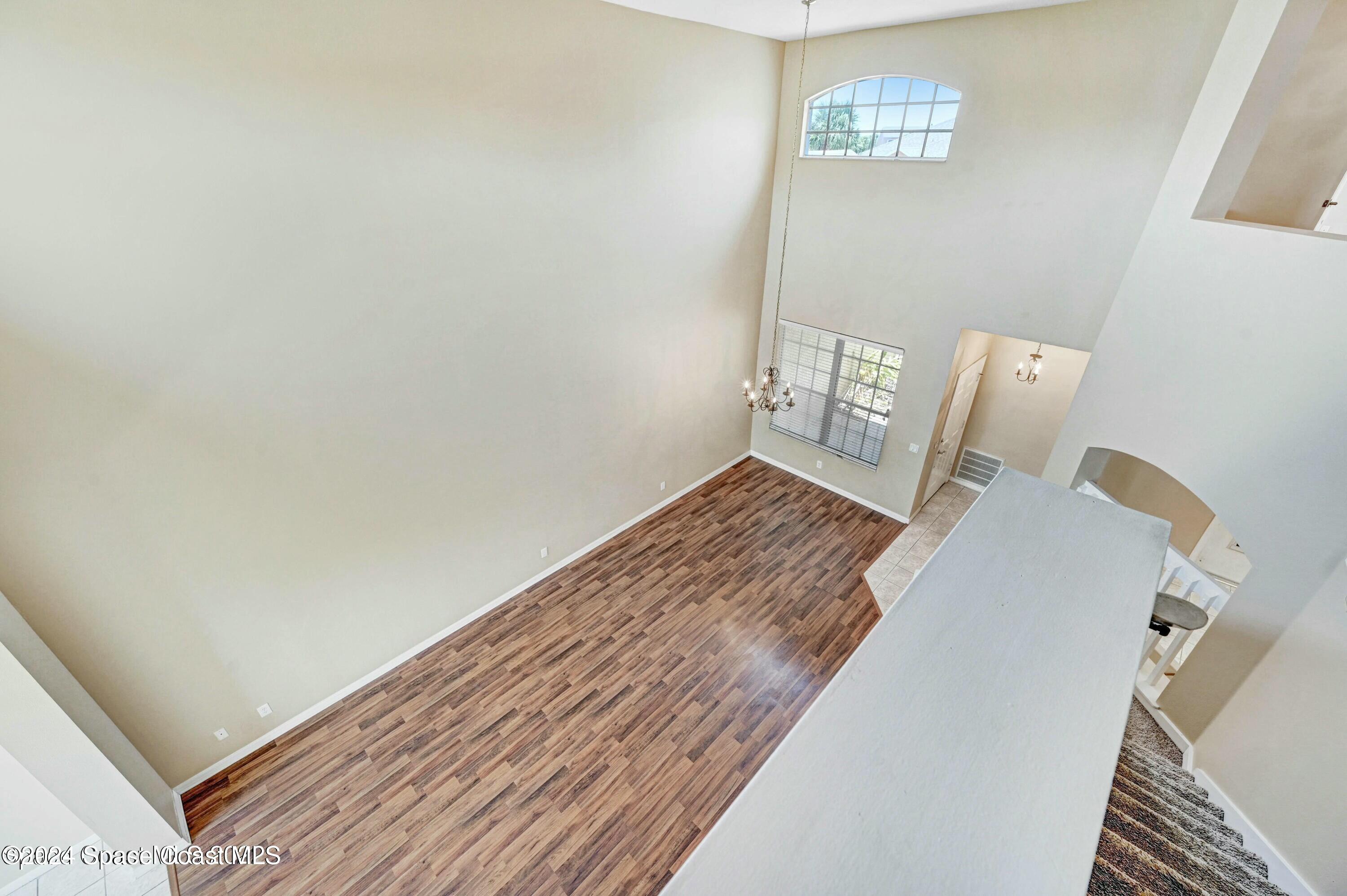 244 Intrepid Way Indialantic, FL 32903 - Photo 24 of 42 a view of a bedroom with wooden floor