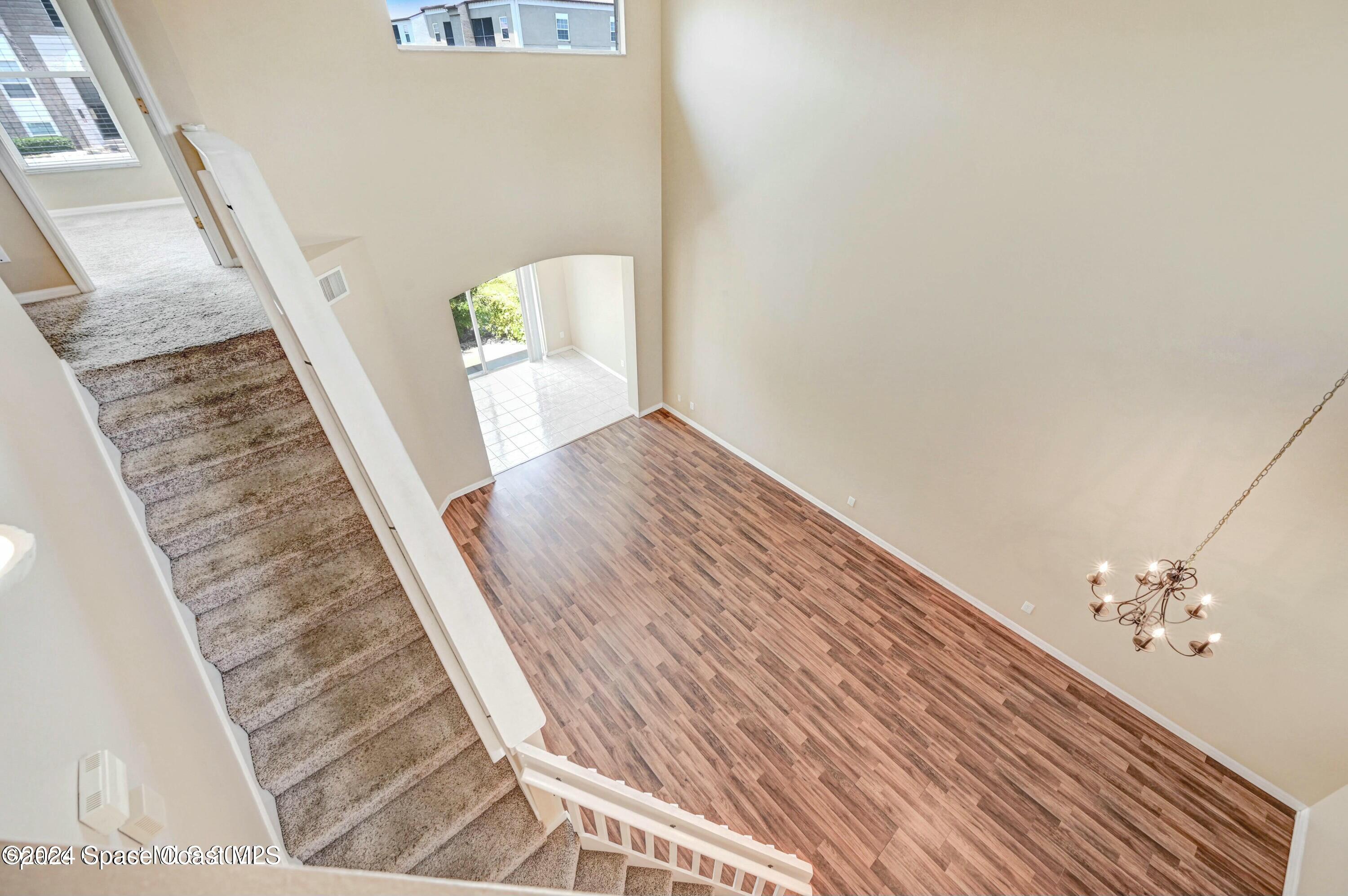 244 Intrepid Way Indialantic, FL 32903 - Photo 28 of 42 a view of a hallway with wooden floor and stairs