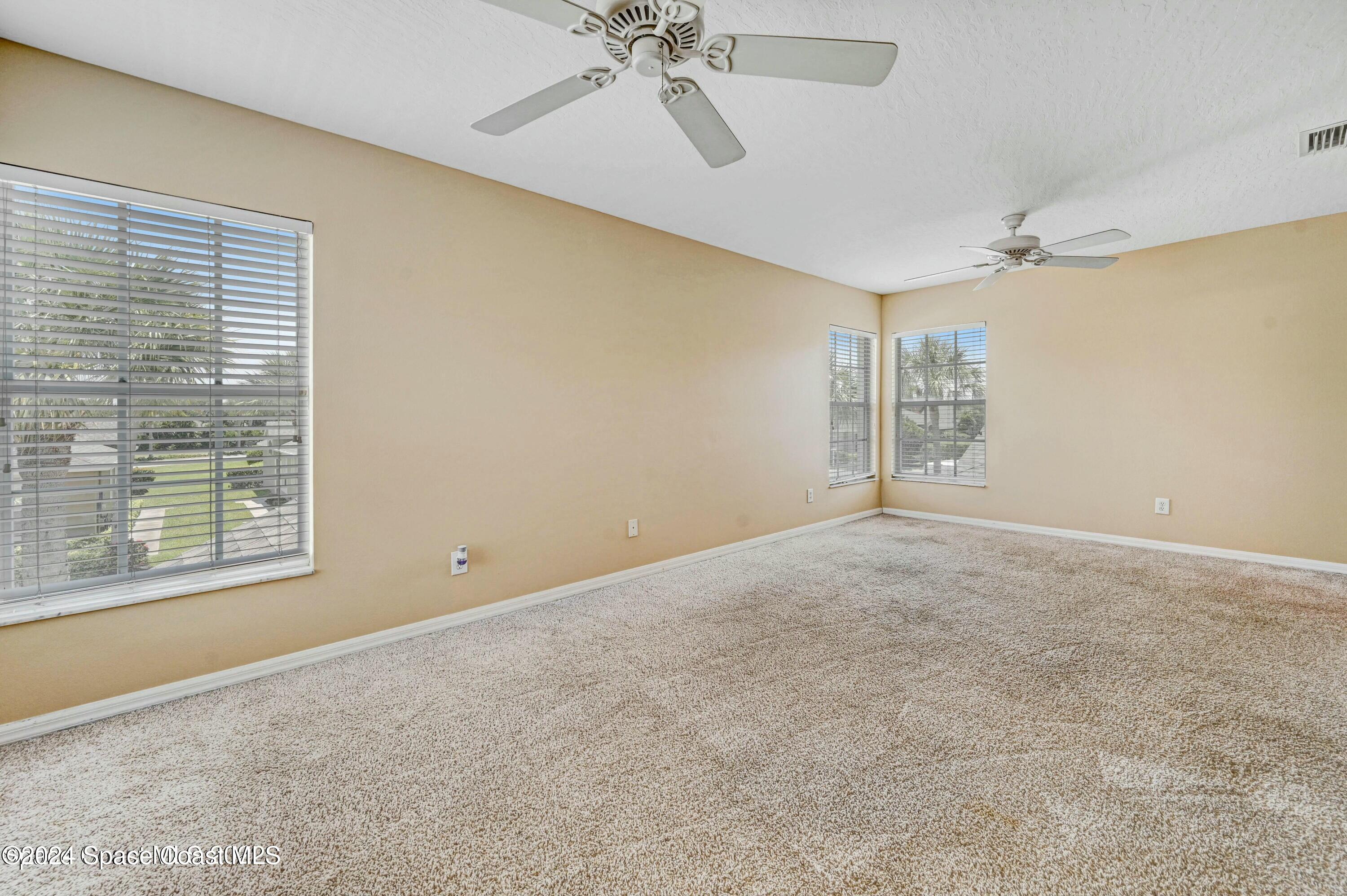 244 Intrepid Way Indialantic, FL 32903 - Photo 30 of 42 an empty room with windows and fan