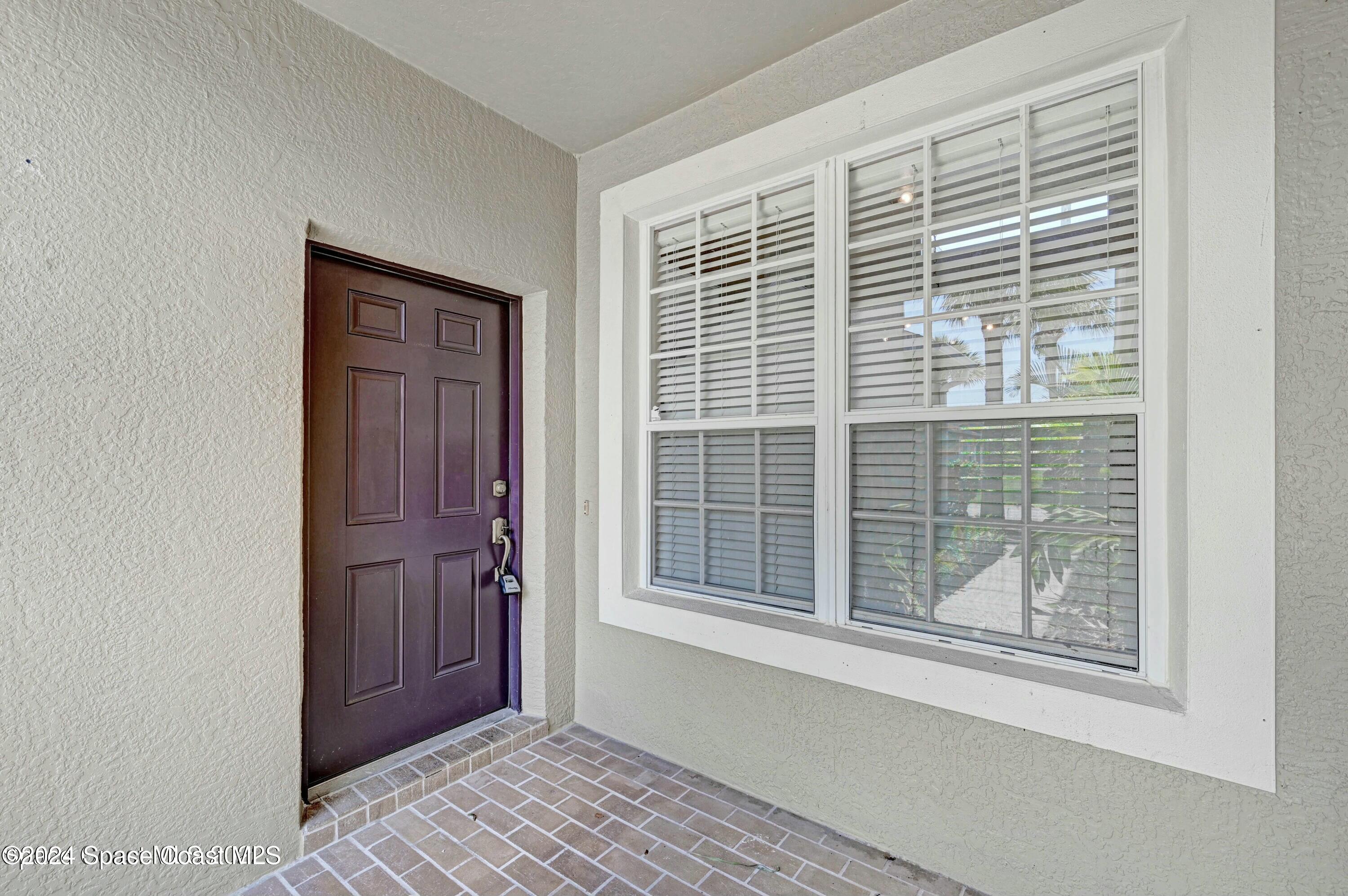 244 Intrepid Way Indialantic, FL 32903 - Photo 4 of 42 a view of empty room with windows