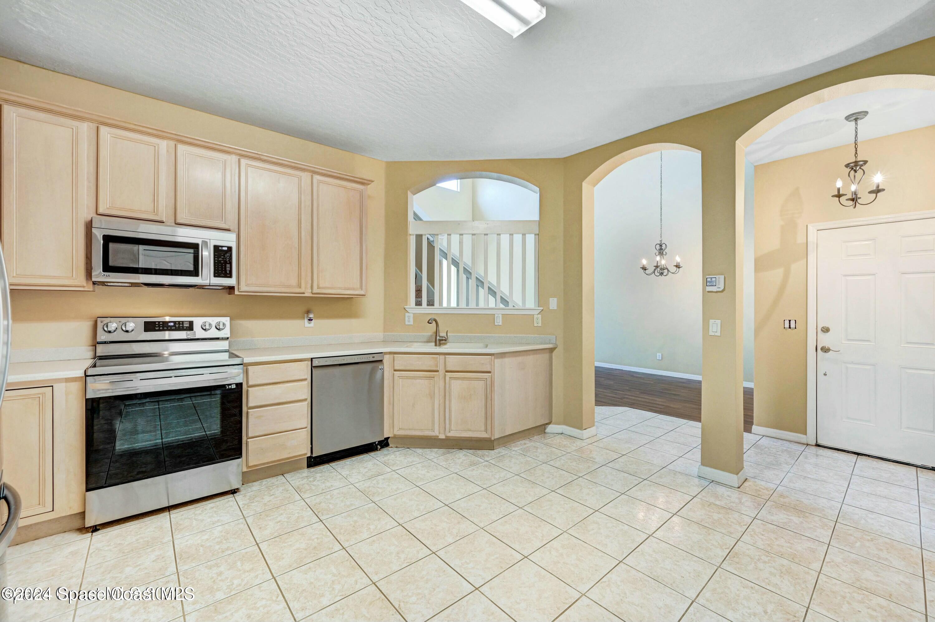 244 Intrepid Way Indialantic, FL 32903 - Photo 7 of 42 a kitchen with a sink cabinets and stainless steel appliances