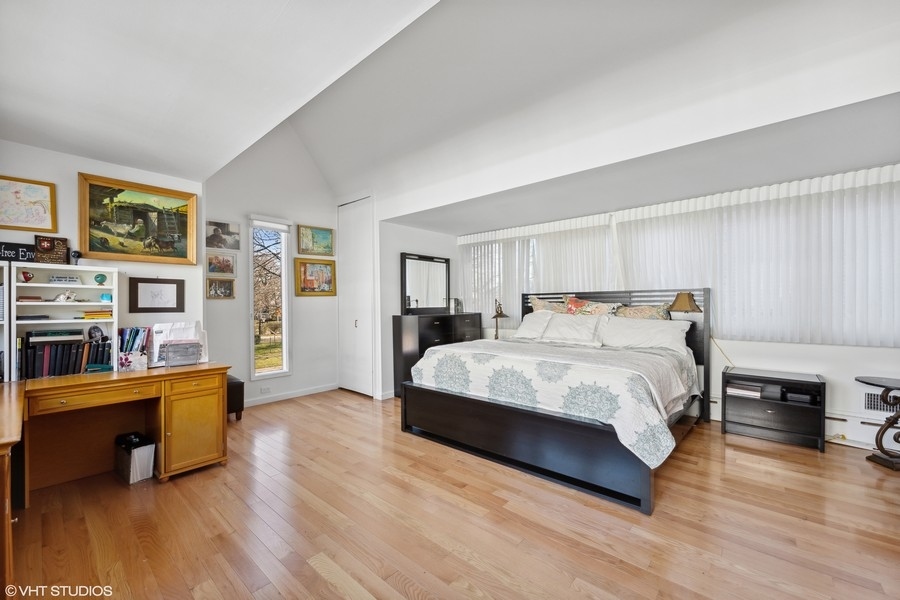 290 Poplar Street Winnetka, IL 60093 - Photo 27 of 55 a spacious bedroom with a bed and wooden floor