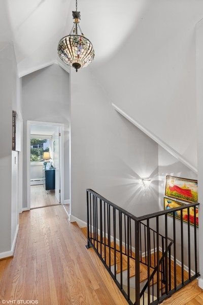 290 Poplar Street Winnetka, IL 60093 - Photo 33 of 55 a view of a hallway with wooden floor and a chandelier