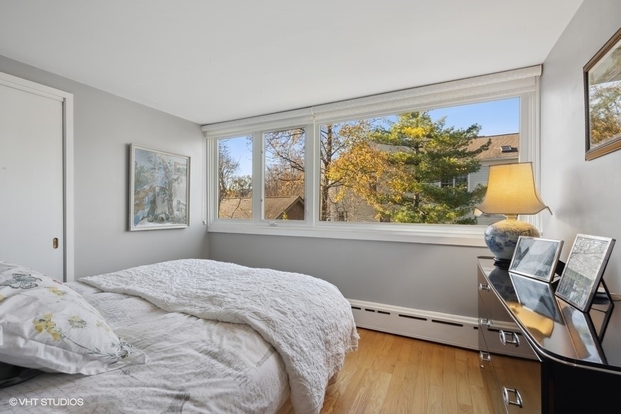 290 Poplar Street Winnetka, IL 60093 - Photo 37 of 55 a bedroom with a bed and wooden floor