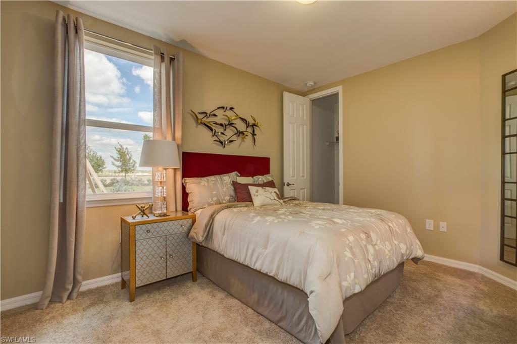 14533 Edgewater Circle Naples, FL 34114 - Photo 11 of 24 a bedroom with a large bed and a window