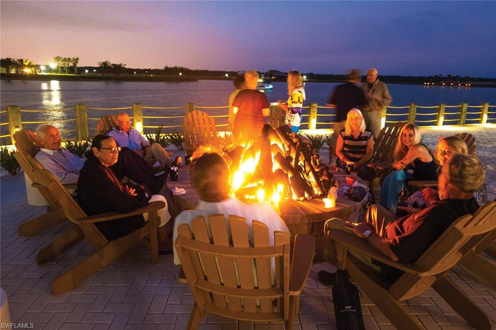 14533 Edgewater Circle Naples, FL 34114 - Photo 20 of 24 a view of a swimming pool with an outdoor seating