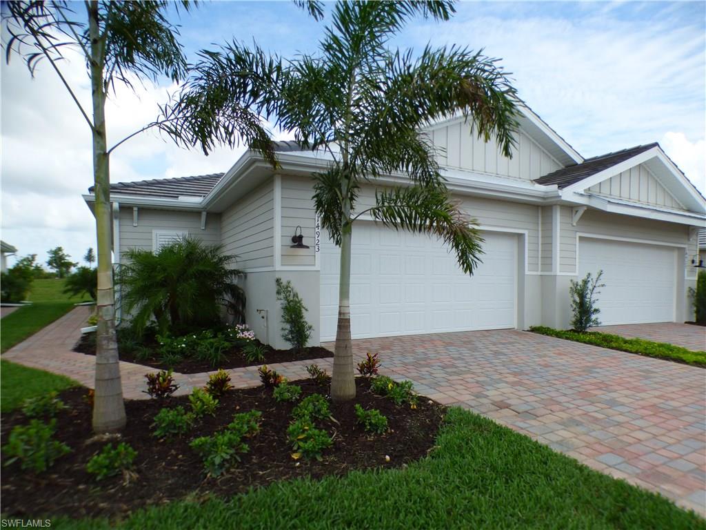 14533 Edgewater Circle Naples, FL 34114 - Photo 3 of 24 a front view of house with yard and green space
