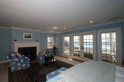 15 Elgin Road Pocasset, MA 02559 - Photo 19 of 29 a bedroom with furniture and a fireplace