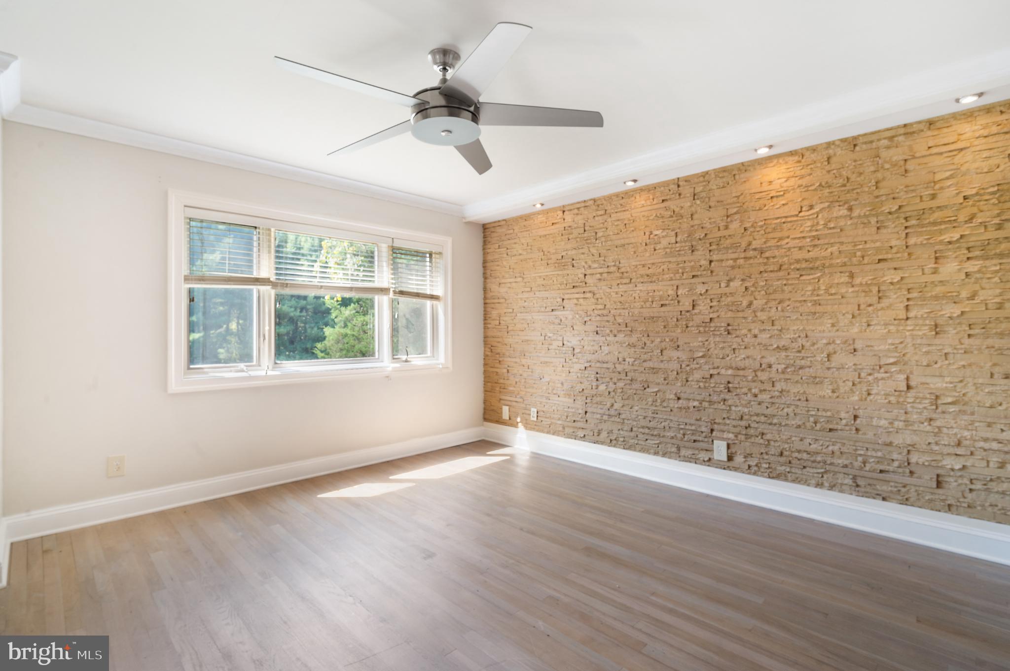 15729 Holly Grove Road Silver Spring, MD 20905 - Photo 50 of 83 a view of an empty room with a window and wooden floor