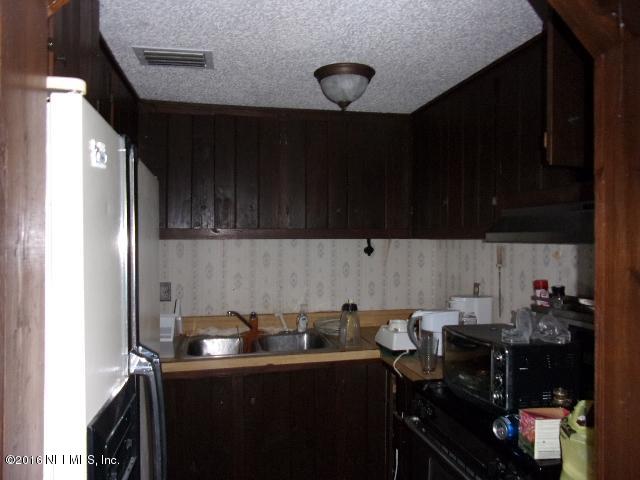 275 Huntington Shortcut Road Crescent City, FL 32112 - Photo 17 of 24 a kitchen with a sink and cabinets