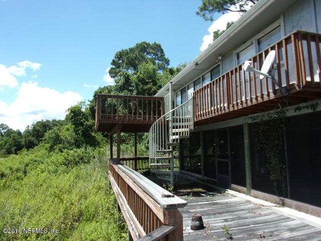 275 Huntington Shortcut Road Crescent City, FL 32112 - Photo 6 of 24 a view of balcony with wooden floor and outdoor seating