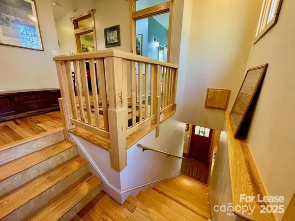 a view of a hallway with windows and stairs