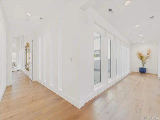 a view of a hallway with wooden floor