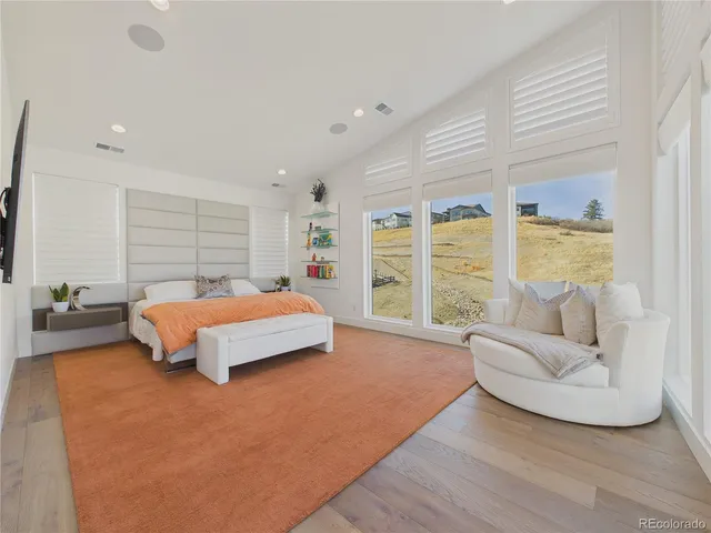 a bedroom with furniture and a large window