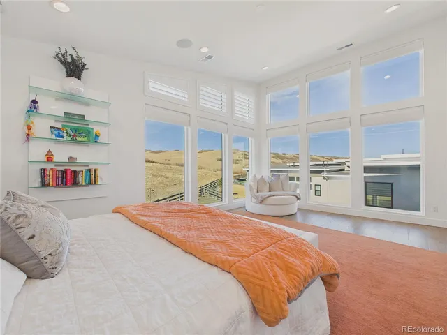 a bedroom with a bed cabinets and a window