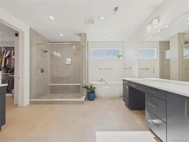 a large spacious bathroom with a tub shower and sink