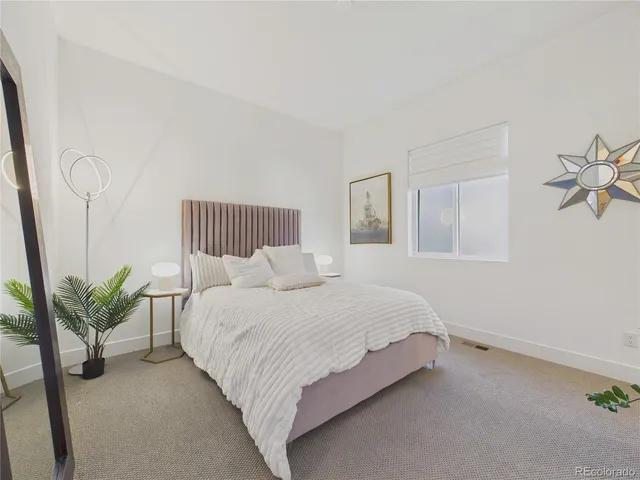 a bed room with a bed and a chandelier