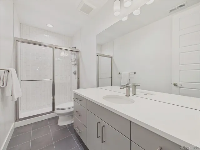 a bedroom with a bed and a night stand