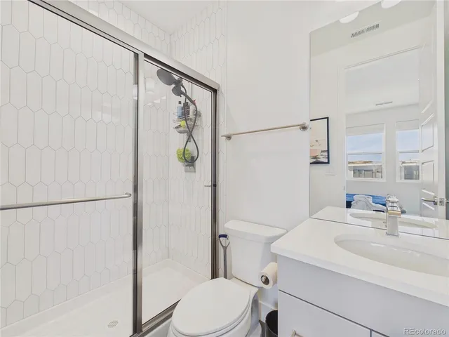 a spacious bedroom with a bed and a flat screen tv