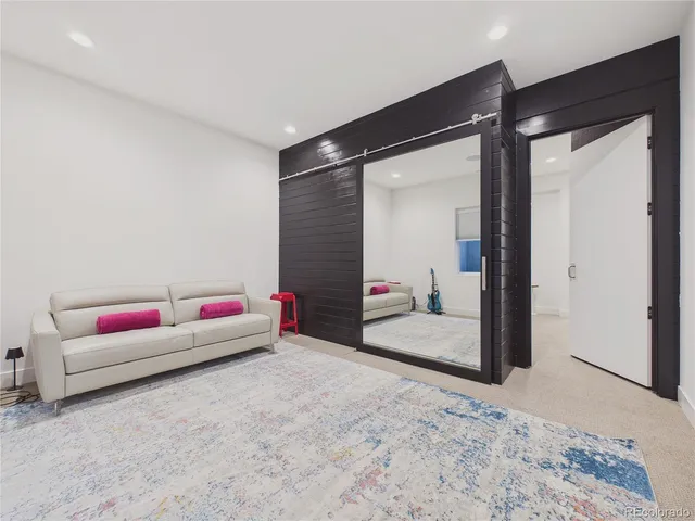 a living room with furniture and white walls