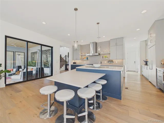 a large kitchen with a table and chairs