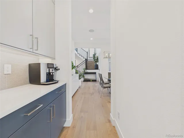 a hallway with sink and mirror