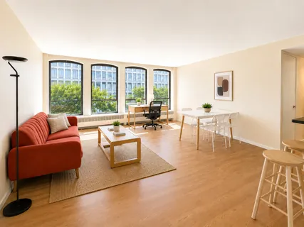 a living room with furniture and floor to ceiling windows
