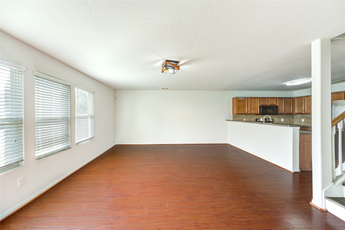 18434 Ranch View Trail Houston, TX 77073 - Photo 14 of 35 an empty room with wooden floor and windows
